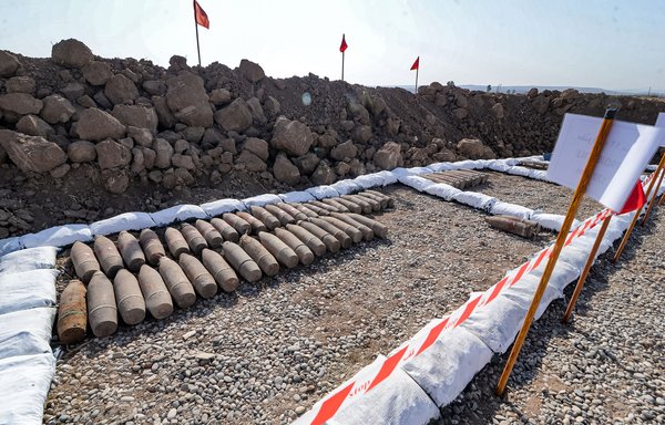 This picture taken on November 29, shows a view of 120mm projectiles recovered by the Global Clearance Solutions private de-mining company in an area near the village of Hassan-Jalad, north of Mosul. [Zaid al-Obeidi/AFP]