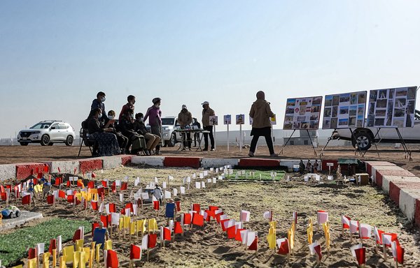 An instructor of Global Clearance Solutions private de-mining company gives a workshop to children on how to report suspected cases of land mines and unexploded ordnance in an area near the village of Hassan-Jalad, north of Mosul, on November 29. [Zaid al-Obeidi/AFP]