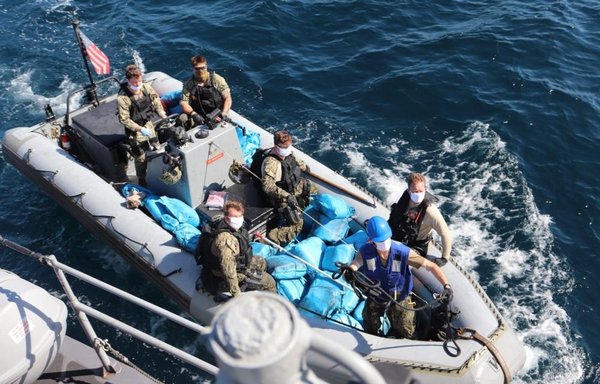 US Navy personnel from the patrol ship USS Sirocco transport illicit drugs seized from a sinking fishing vessel in the Gulf of Oman on December 15. [US Navy]