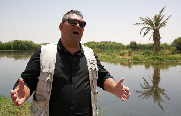 Hazem Hrisha, director of Jordan's Azraq Wetland Reserve, is seen here on June 10. Jordan is racing against time to save the tiny rare Dead Sea toothcarp fish from extinction as falling water levels partly triggered by global warming threaten to dry up its last habitat. [Khalil Mazraawi/AFP]