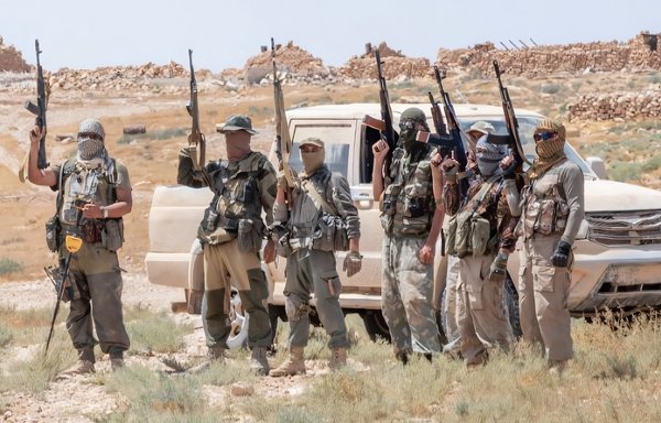 Wagner Group mercenaries brandish their weapons in the eastern desert (Badiya) of Syria. [File]