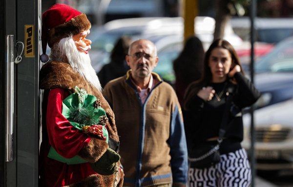 This picture taken on December 14 shows a statue of Santa Claus outside the entrance of a toy shop in the popular market of Burj Hammoud in Lebanon. [Joseph Eid/AFP]