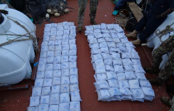 US Navy personnel from coastal patrol ships USS Tempest and USS Typhoon inventory a shipment of illegal drugs aboard a stateless dhow in the Arabian Sea on December 27. [US Navy]