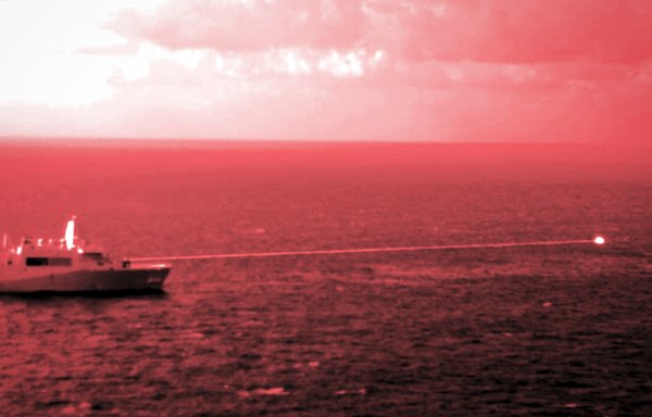 In this photograph captured utilising a short wave infrared lens and optical filter, sailors aboard the USS Portland use a high-energy laser weapon system on a static surface training target on December 14 while sailing in the Gulf of Aden. [US Navy]