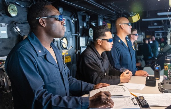 Sailors aboard the USS Portland observe a high-energy laser weapon system demonstration on a static surface training target on December 14 while sailing in the Gulf of Aden. [US Navy]