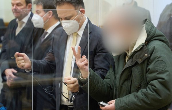 Former Syrian intelligence officer Anwar Raslan (R) gestures in the courtroom at a courthouse in Koblenz, western Germany, on January 13, on the last day of his trial where he was sentenced to life in jail for crimes against humanity in the first global trial over state-sponsored torture in Syria. [Thomas Frey/Pool/AFP]