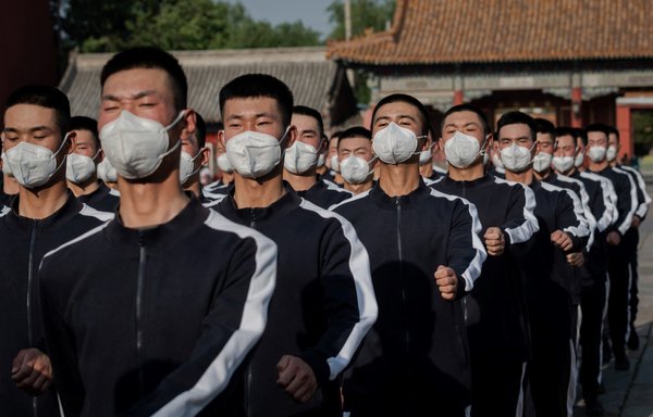 Chinese People's Liberation Army (PLA) soldiers in sports uniforms march in Beijing on May 22, 2020. That year, the government announced a 6.6% increase in its military budget. [Nicolas Asfouri/AFP]
