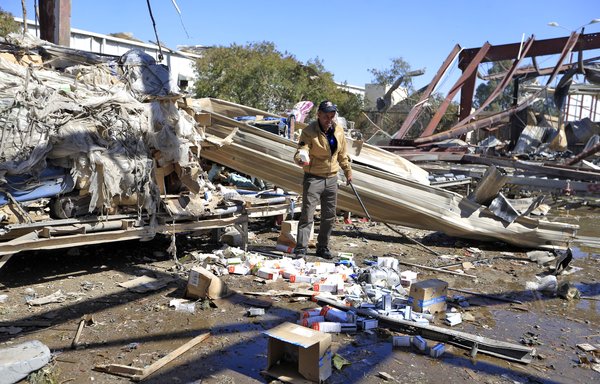 An airport worker searches through the debris of a building destroyed following a reported air strike by the Saudi-led coalition targeting the Sanaa International Airport on December 21. [Mohammed Huwais/AFP]