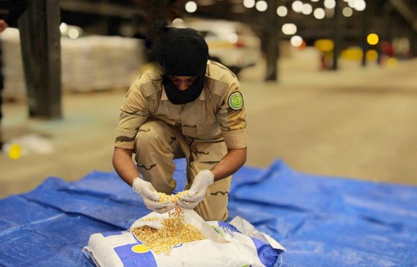 A Saudi General Directorate of Narcotics Control officer inspects illegal drugs seized at the Saudi border in co-operation with the UAE authorities. [Saudi General Directorate of Narcotics Control]