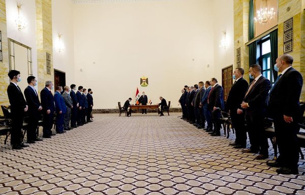 Iraqi and Chinese officials attend a signing ceremony December 16 for a deal in which China will build 1,000 schools in Iraq. [Iraqi prime minister's office]