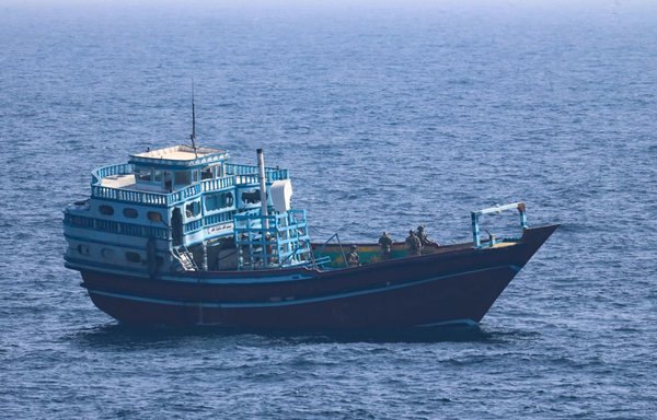 US service members board a stateless fishing vessel transiting international waters in the Gulf of Oman on January 18. [US Navy]