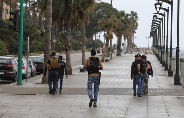 A picture taken March 16, 2020, shows Lebanese intelligence officers patrolling a street in Beirut. [Anwar Amro/AFP]
