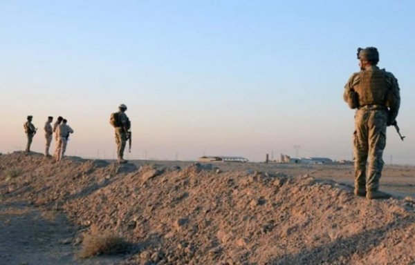 Members of the Jordanian security forces stand on an earthen berm in an undated photo. [Syrian Observatory for Human Rights]