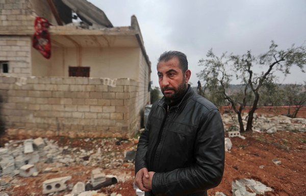 A neighbour of the residence in which ISIS leader Ibrahim al-Hashimi al-Qurashi died, during a raid by US special forces, is pictured near the house in the Idlib province town of Atme on February 4. [Aaref Watad/AFP]