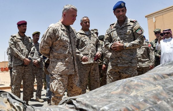 US CENTCOM commander Gen. Kenneth F. McKenzie and Lt. Gen. Fahd bin Turki bin Abdulaziz al-Saud (C), commander of the Saudi-led coalition forces in Yemen, are shown by coalition spokesman Turki al-Maliki (C-R) reportedly Iranian weapons seized by Saudi forces from Yemen's Houthis, during a visit to a military base in al-Kharj in central Saudi Arabia on July 18, 2019. [Fayez Nureldine/AFP]