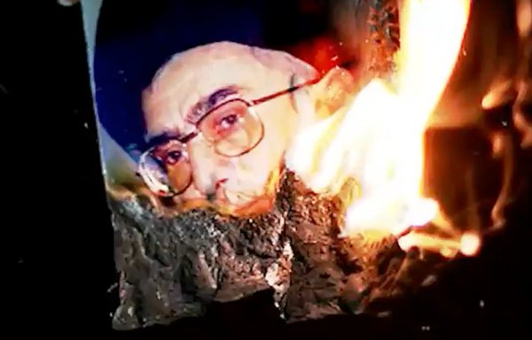 A video screenshot of an Iranian woman burning a picture of Iran's Supreme Leader Ali Khamenei. [File]