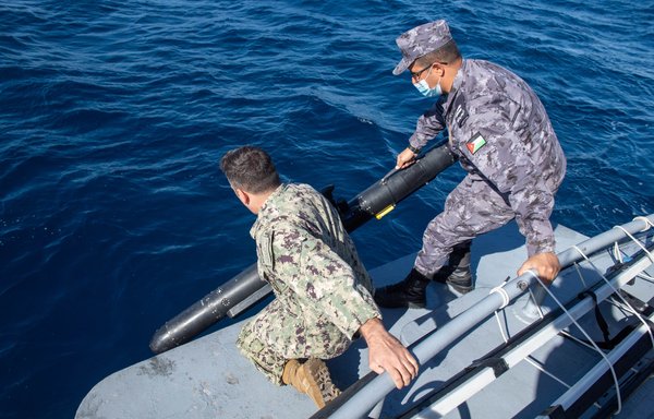 NATO Centre for Maritime Research and Experimentation sailors and members of the Royal Jordanian Navy lower a Slocum Glider unmanned undersea vehicle into the Gulf of Aqaba during the IMX22 joint drills on February 8. [USCENTCOM]