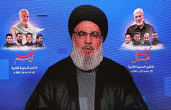 This picture taken January 3 shows a screen displaying a televised speech by Hizbullah chief Hassan Nasrallah during an anniversary commemoration of the death of IRGC Quds Force commander Qassem Soleimani and his Iraqi lieutenant. [Anwar Amro/AFP]