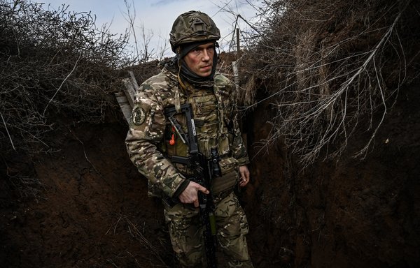 Ukrainian troops patrol at the frontline outside the town of Novoluhanske, eastern Ukraine, on February 19. Ukraine's army that day said that two of its soldiers died in attacks on the frontline with Russian-backed separatists, the first fatalities in the conflict in more than a month. [Aris Messinis/AFP]
