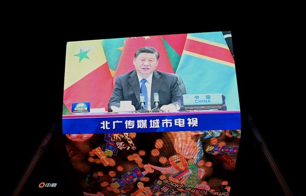 China's President Xi Jinping is pictured on a big screen during an evening news programme, showing Xi's keynote speech at the opening ceremony of the 8th Forum on China-Africa Co-operation (FOCAC) at a mall in Beijing on November 30. [Noel Celis/AFP]