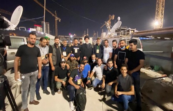 Hameed al-Hussaini, director of the Iran-linked Islamic Radio and Television Union, stands amidst a number of workers of union-affiliated media organisations after they covered the al-Arbaeen pilgrimage in this photo published October 9, 2020. [IRTVU website]