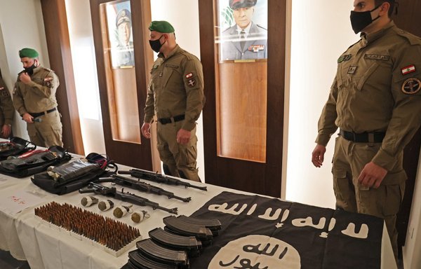Lebanese Internal Security Forces display weapons the Ministry of Interior said were seized from ISIS during a pre-emptive operation, at a press conference in Beirut on February 23. [Anwar Amro/AFP]