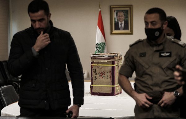 Members of Lebanon's security forces present in a news conference a seized cache of Captagon tablets that was hidden in tea boxes to be smuggled, at the headquarters of the Internal Security Forces in Beirut on January 25. [Anwar Amro/AFP]