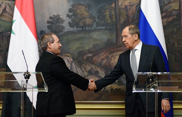 Russian Foreign Minister Sergey Lavrov (R) shakes hands with Syrian Foreign Minister Faisal Meqdad at the end of a news conference following a meeting in Moscow on February 21. [Alexander Nemenov/Pool/AFP]