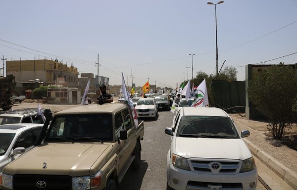 Iran-backed militia Asaib Ahl al-Haq stages an armed parade in Iraq's Dhi Qar province on May 7. [Ibn Al-Asaib/Twitter]