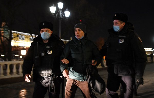 Police officers detain a man during a protest against Russia's invasion of Ukraine in Moscow on March 2. [Natalia Kolesnikova/AFP]