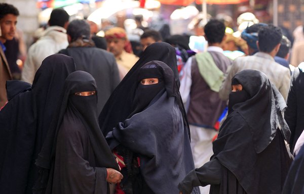 In this photo taken March 2, 2020, Yemeni women walk in the market of Sanaa's old city. [Mohammed Huwais/AFP]