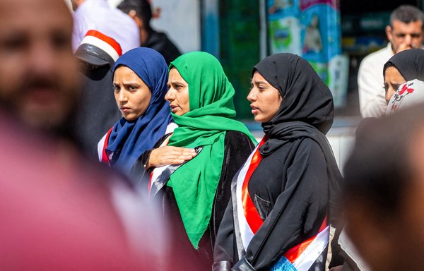 Women wearing sashes in the colours of the Yemeni flag attend a rally in Taez on February 12 to commemorate the 11th anniversary of the 2011 Arab Spring uprising that toppled former president Ali Abdullah Saleh. [Ahmad al-Basha/AFP]