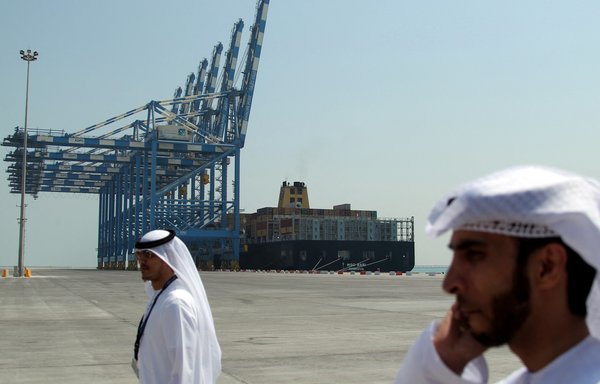 Employees walk in the Khalifa Port in Abu Dhabi on September 1, 2012. US intelligence officials have expressed concern in recent months over Chinese activity at the port. [Karim Sahib/AFP]