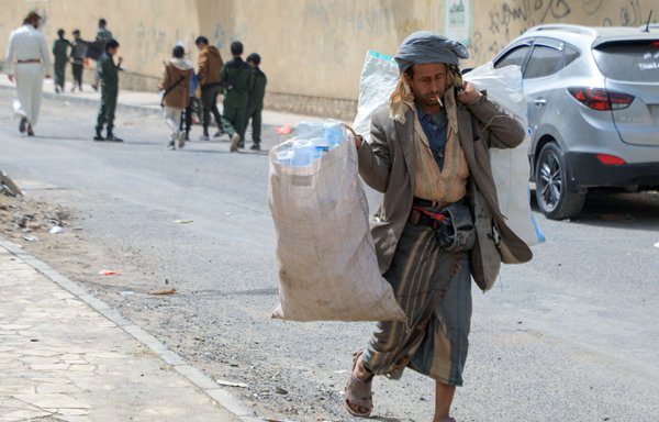 A Yemeni man collects plastic waste from the streets in the capital Sanaa on March 19. The UN and aid groups on March 19 warned of grave consequences for Yemen after an international pledging conference failed to raise enough money to prevent a humanitarian catastrophe. [Mohammed Huwais/AFP]