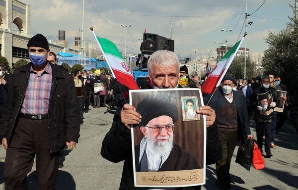 An Iranian man holds a picture of the country's leader Ayatollah Ali Khamenei during a rally in support of the Houthis in Yemen, following Friday prayers in Tehran, on January 28. [AFP]