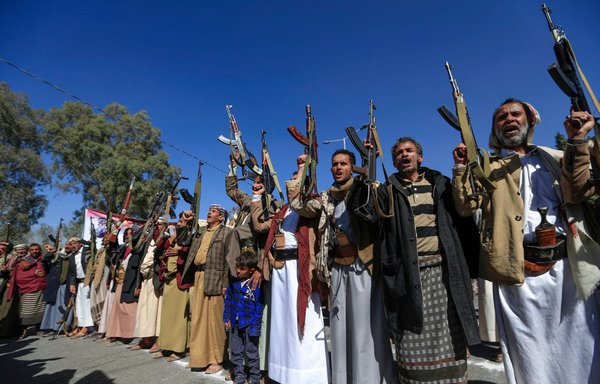 Supporters of Yemen's Houthis raise firearms as they chant slogans during a demonstration in Sanaa on January 18, 2021. [Mohammed Huwais/AFP]