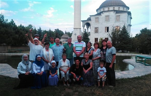 Muslims pose for a photograph outside the mosque of Sultan Suleiman the Magnificent and his wife Roxolana (Hurrem Sultan) in Mariupol on August 18, 2020. [Sultan Suleiman the Magnificent Mosque/Facebook]
