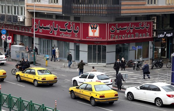 A branch of the Parsian bank is pictured in the capital Tehran on March 9. The Iranian regime has set up a clandestine banking and financial network to handle tens of billions of dollars in annual trade that was banned under international sanctions. [Atta Kenare/AFP]