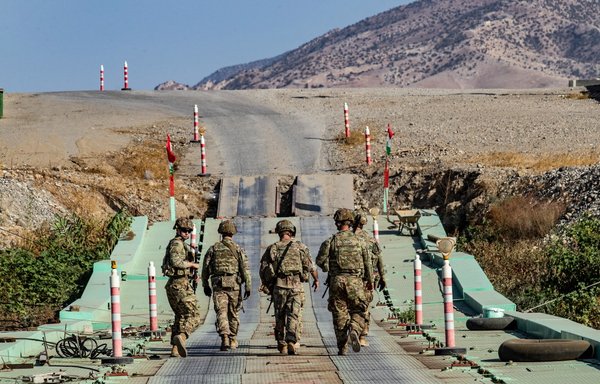 US soldiers patrol an area near Syria's northeastern Semalka border crossing with Iraq's Kurdish region on November 1, 2021. [Delil Souleiman/AFP]