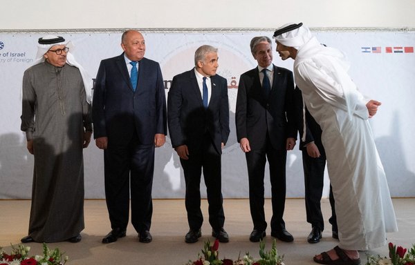 Bahrain's Foreign Minister Abdullatif bin Rashid al-Zayani, Egypt's Foreign Minister Sameh Shoukry, Israel's Foreign Minister Yair Lapid, US Secretary of State Antony Blinken, Morocco's Foreign Minister Nasser Bourita listen as the UAE's Foreign Minister Sheikh Abdullah bin Zayed Al Nahyan speaks to them as they pose for a group photo following their meeting in the Israeli kibbutz of Sde Boker on March 28. [Jacquelyn Martin/Pool/AFP]