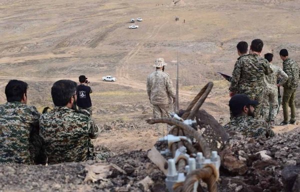 Fatemiyoun Division militiamen are seen here at a training location in the desert near the Syrian border town of Albu Kamal. [DEFA Press]