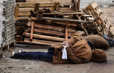 Retreating Russian forces in Ukraine leave behind mass graves, bodies in the streets