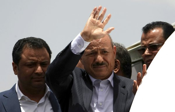 In this file photo from June 13, 2012, Rashad al-Alimi, then-deputy prime minister for security affairs, waves as he arrives at Sanaa airport after receiving medical treatment in Saudi Arabia. Al-Alimi will now head a new presidential council in Yemen. [Mohammed Huwais/AFP]