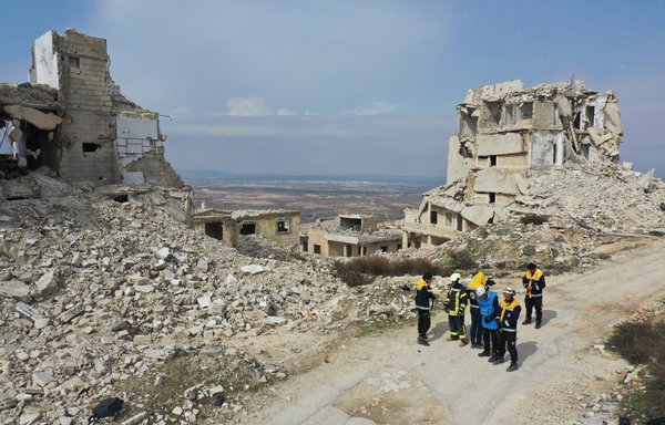Members of the White Helmets speak about their rescue skills during a video shoot for an instructive film intended for Ukrainian rescuers, in the Syrian town of Ariha on March 16. [Omar Haj Kadour/AFP]