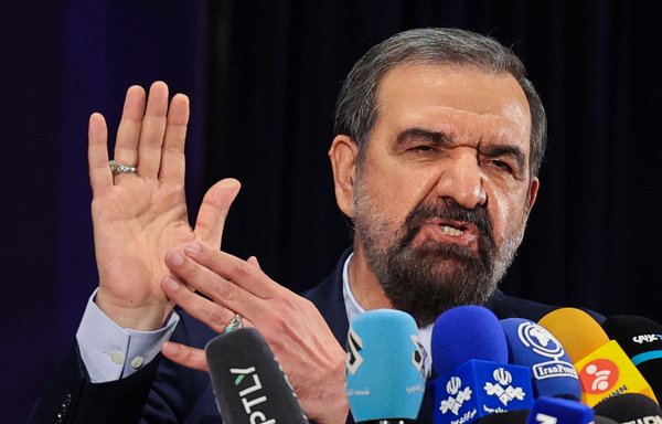 Former IRGC chief Mohsen Rezaei talks to the media after registering his candidacy for the June 2021 presidential elections, at the Interior Ministry in Tehran, on May 15. [Atta Kenare/AFP]