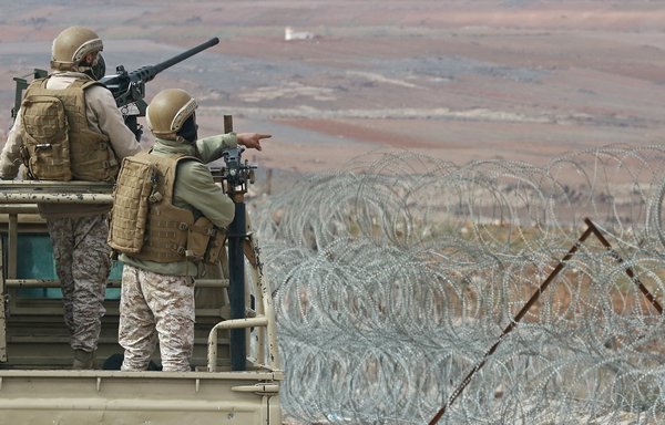 A picture taken during a tour organised by the Jordanian Army shows soldiers patrolling along the border with Syria to prevent smuggling, on February 17. [Khalil Mazraawi/AFP]