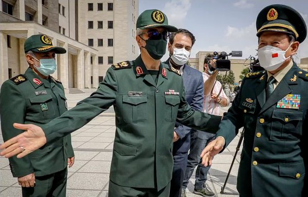 Iranian Defence Minister Mohammad-Reza Ashtiani (centre) gestures as Chinese Defence Minister Wei Fenghe (right) visits Tehran on April 27. [Iranian Ministry of Defence]