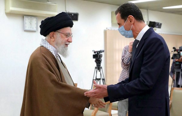 Iranian leader Ali Khamenei greets Syrian president Bashar al-Assad in Tehran on May 8. [Khamenei.ir]