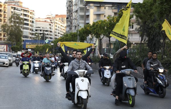 Lebanese youths supporting the Iran-backed Hizbullah and the Amal movement hold a motorbike rally in Beirut's southern suburb on May 9. [Ibrahim Amro/AFP]