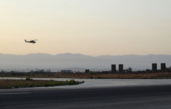 A Russian Kamov helicopter flies near S-300 missile system at the Hmeimim military base in Latakia province, in northwest Syria, on September 12, 2017. [Maria Antonova/AFP]